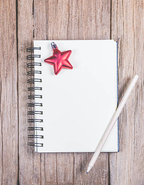 istock white blank space notebook with pencil and christmas ornament 619738438