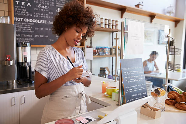 istock Waitress writing down an order at a coffee shop, close 619738632