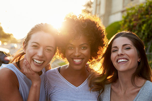 portrait of three young adult female friends in the street - version 3 imagens e fotografias de stock