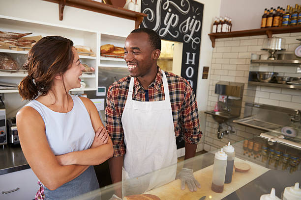 istock Couple working at a sandwich bar looking at each other 619738948