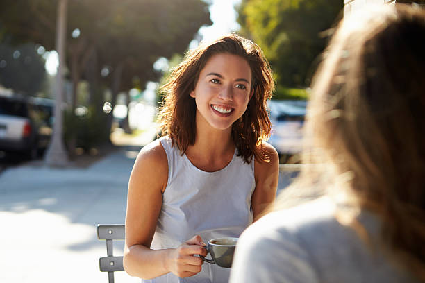 istock Two female friends talking over coffee outside a cafe 619738980