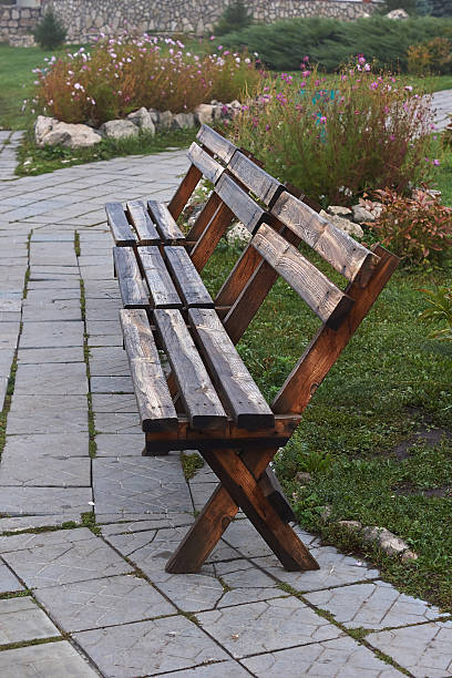istock Wet bench in autumn park. 619739538