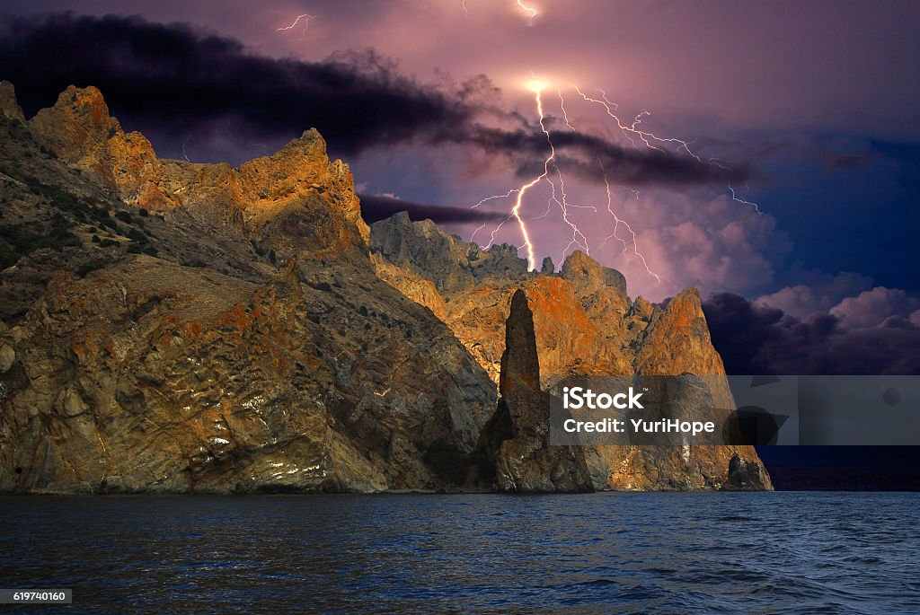 Thunderstorm and lightning over the coast of the Black Sea, Crimea Eastern Crimea, near Koktebel, rocky shore of the Black sea. During a lightning storm Awe Stock Photo