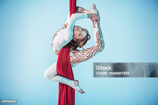 Graceful Gymnast Performing Aerial Exercise Stock Photo - Download Image Now - Aerial View, Gymnastics, Acrobat