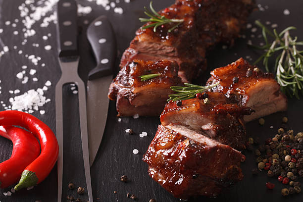 istock Spicy pork ribs BBQ closeup with the ingredients. horizontal 619740808