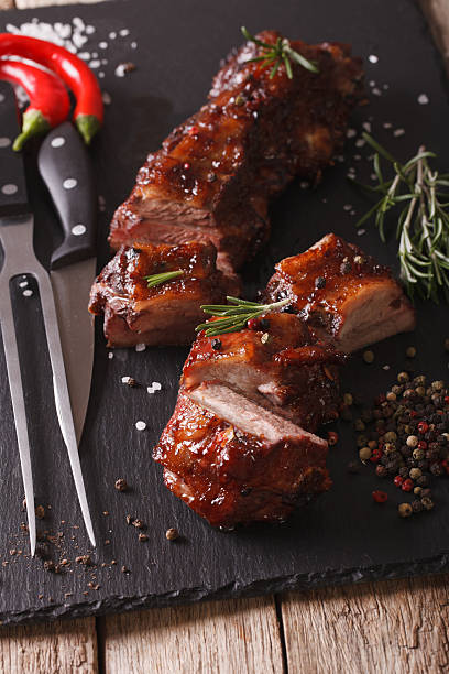 istock BBQ pork ribs close-up on table with the ingredients. vertical 619741716