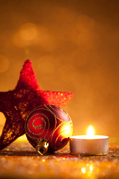 istock Candle and bauble on glitter with gold background 619741924