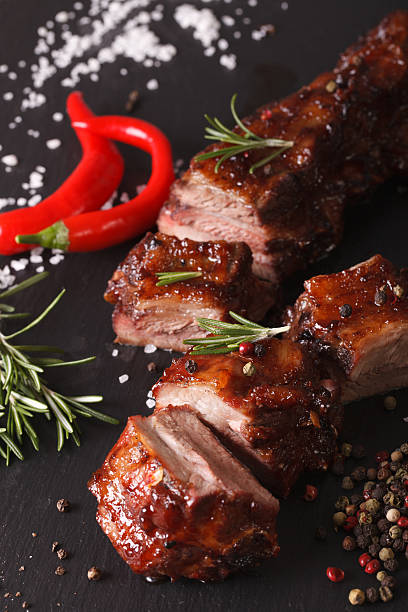 istock pork ribs BBQ closeup on the table with the ingredients 619742106