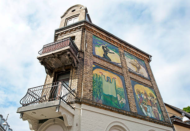 Aalborg,Denmark- June 22, 2016: Ornate corner house with balconies and colourful murals in old Aalborg, Denmark. Much of Aalborg was flattened to make way for industialisation in the early 20th century but several examples of middle age and medieval architecture remain together with interesting architecture and decoration around the old quarter.