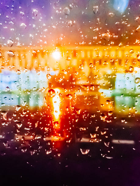istock Not sharp water drops on glass with coloured lights 619745426