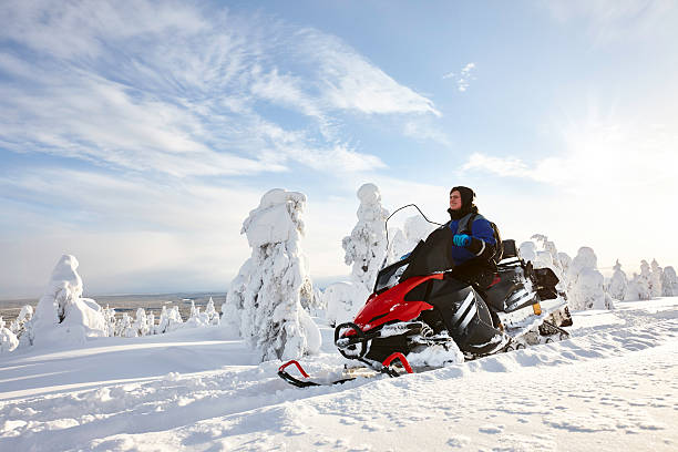 мужчина за рулем снегохода в финляндии - snowmobiling adventure snow travel стоковые фото и изображения