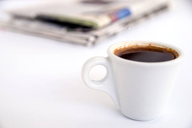 istock cup of freshly brewed coffee on the table with newspaper 619745858