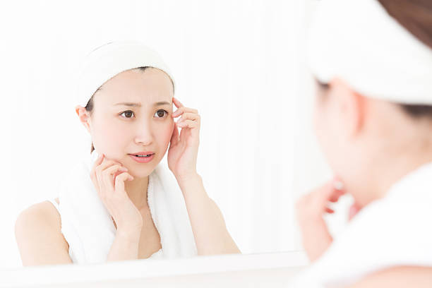 istock Woman looking in a mirror 619746288