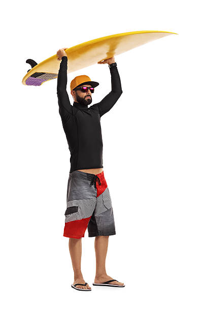 istock Surfer holding a surfboard above his head 619747354
