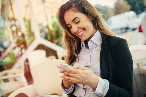 Happy businesswoman using phone