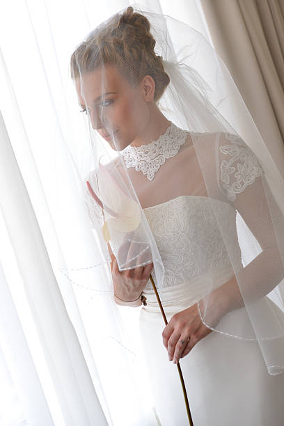 istock Georgeus young bride with flower indoors 619749898