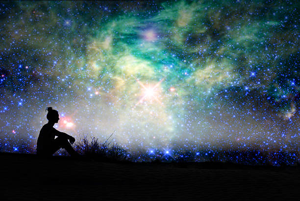 silueta de una mujer sentada afuera, fondo nocturno estrellado - constelación fotos fotografías e imágenes de stock
