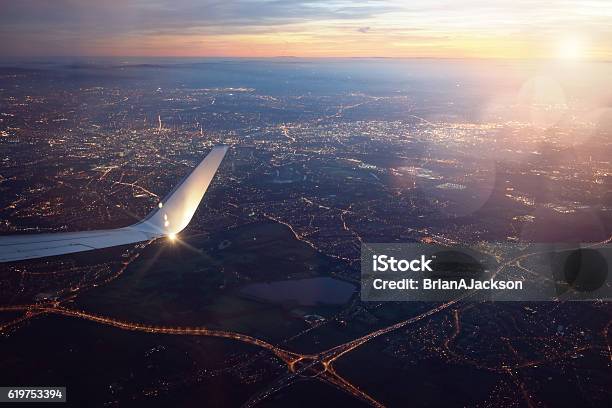 View From Landing Airplane Window Of City At Sunset Stock Photo - Download Image Now