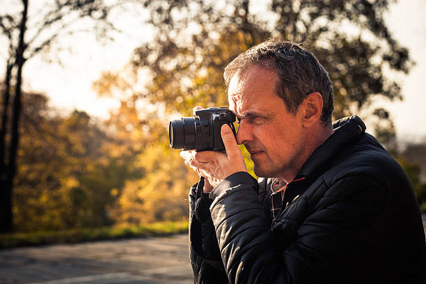 istock photographer with digital camera outdoor 619753632