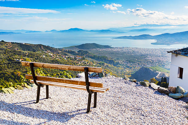 Volos city view from Pelion mount, Greece Bench overlooking Volos city and sea gulf aerial view from Pelion mount, Greece pilio greece stock pictures, royalty-free photos & images