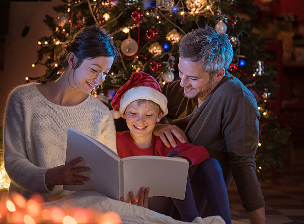 istock Christmas night. a nice family reading a book together 619754750