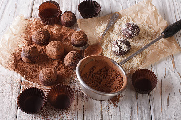 istock sprinkling chocolate truffles cocoa powder and nuts. Horizontal 619754964