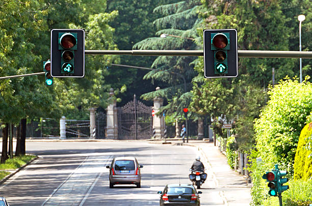 istock green street light  with traffic 619755144