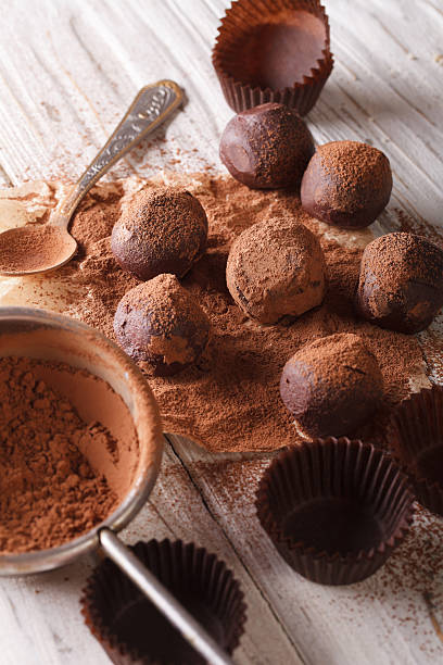istock chocolate truffles sprinkled with cocoa powder close-up. Vertical 619756300