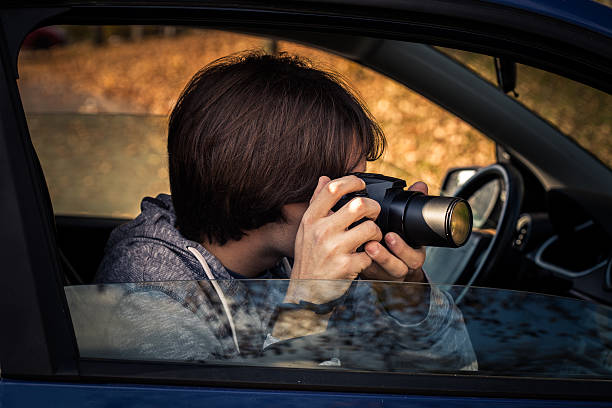 istock photographer with digital camera take photo from car 619757210