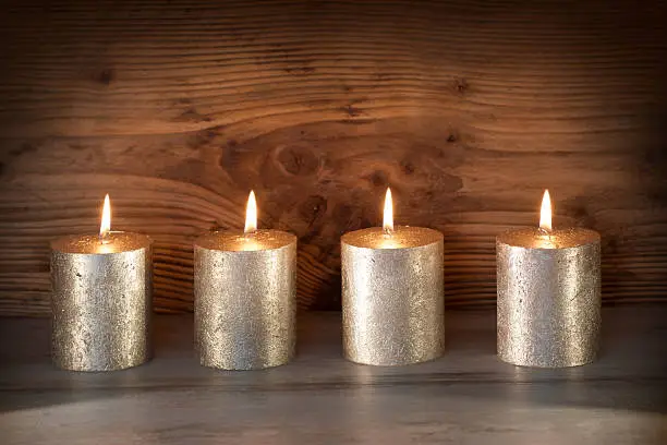 Noble candles in front of a wooden background for celebratory moments