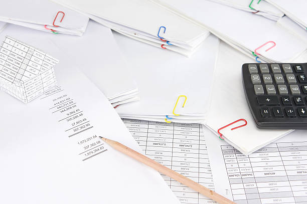 istock Pencil on earnings statement have blur house and paperwork 619757552