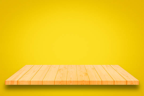 istock Wooden shelf on yellow gradient wall background. 619757686