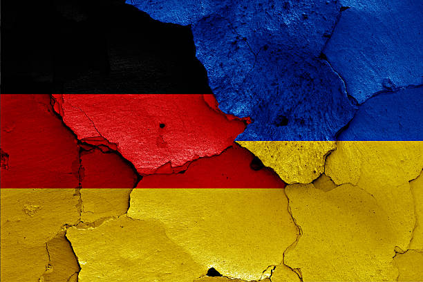 istock flags of Germany and Ukraine painted on cracked wall 619758102