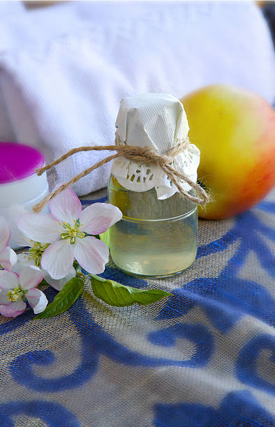 istock Glass bottle of apple blossoms extract. 619759398
