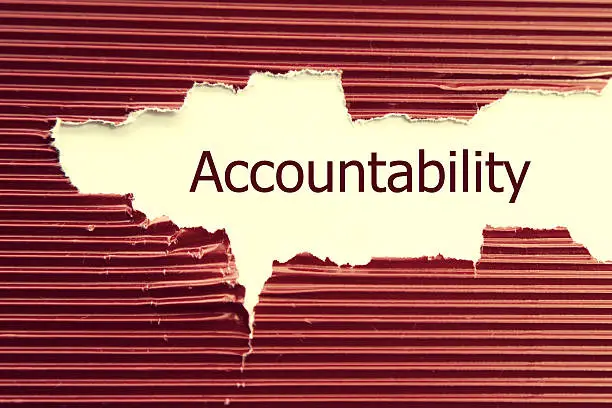 Photo of Accountability word written under torn paper.