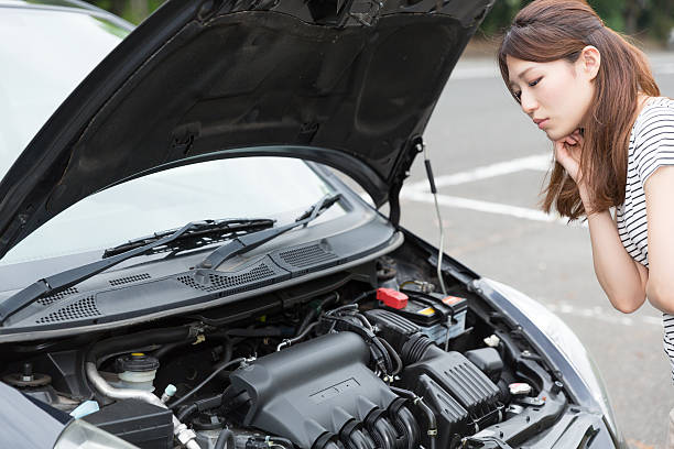 istock Woman standing next to open car bonnet 619759884