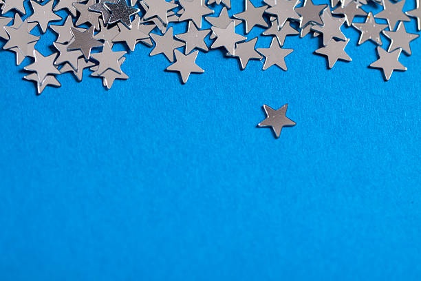 istock Frame of scatters little silver stars on blue background. 619760626