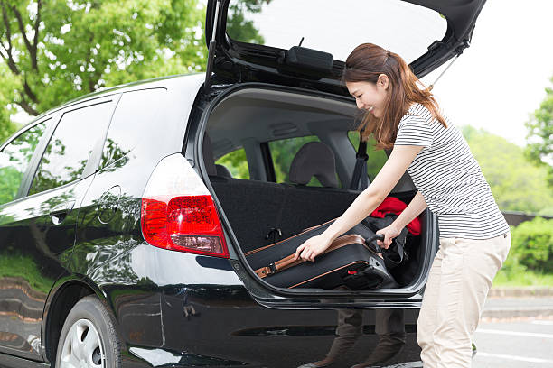 istock Woman standing next to a car boot 619760920