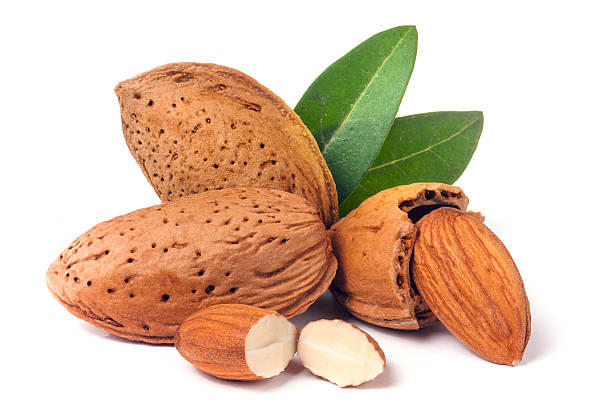 istock almonds in their skins and peeled with leaf isolated on 619760972