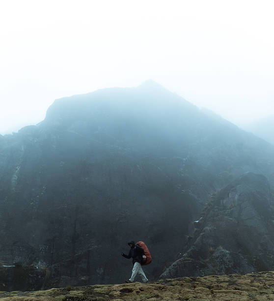 istock Hiker walking in front of a mountain 619762018