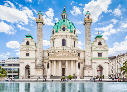 Beautiful view of famous Wiener Karlskirche (Saint Charles's Church) at Karlsplatz with blue sky and clouds on a sunny day in summer, Vienna, Austria.