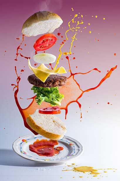 A hamburger (or cheeseburger when served with a slice of cheese) is a sandwich consisting of one or more cooked patties of ground meat, usually beef, placed inside a sliced bread roll or bun. Hamburgers may be cooked in a variety of ways, including pan-frying, barbecuing, and flame-broiling. Hamburgers are often served with cheese, lettuce, tomato, bacon, onion, pickles, and condiments such as mustard, mayonnaise, ketchup, relish, and chiles.