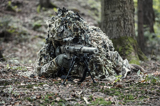 istock sniper wearing ghillie suit 619764776