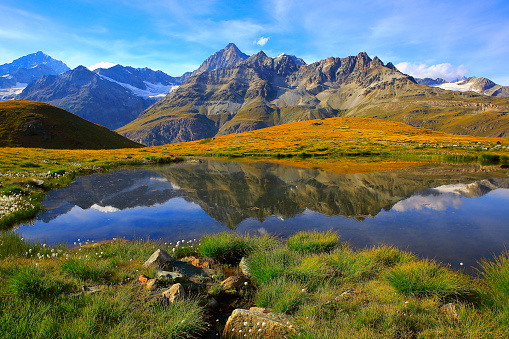 Swiss alps, lake reflection, golden autumn alpine meadow, Zermatt