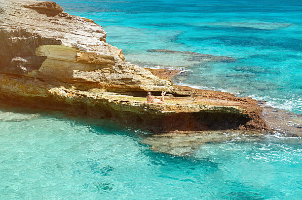 istock One woman lay on rock 619764996