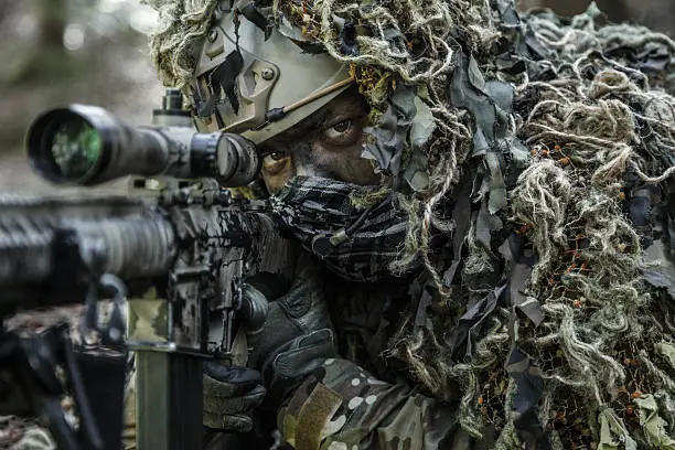 Photo of sniper wearing ghillie suit