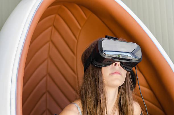 istock Girl playing game in virtual reality glasses 619765570