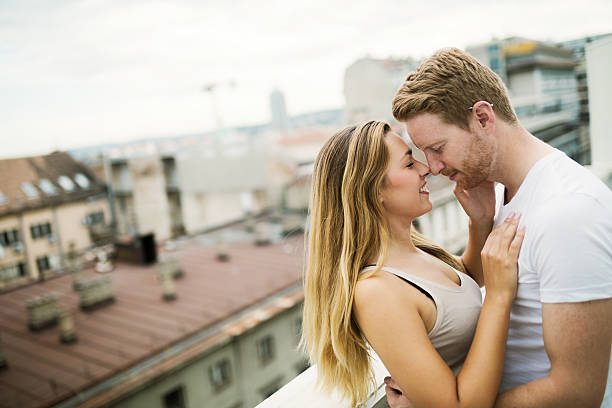 istock Sensual couple rooftop romance 619767886