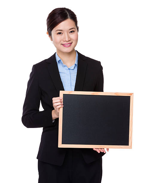istock Businesswoman holding a chalkboard 619769336