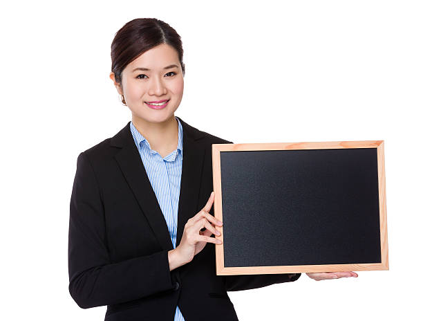 istock Businesswoman holding a chalkboard 619769388